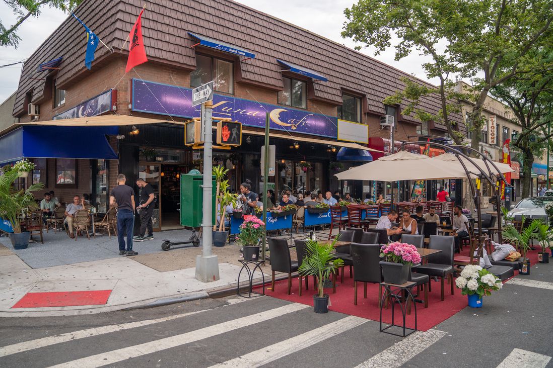 outdoor dining, with many seats and tables curbside and on sidewalk